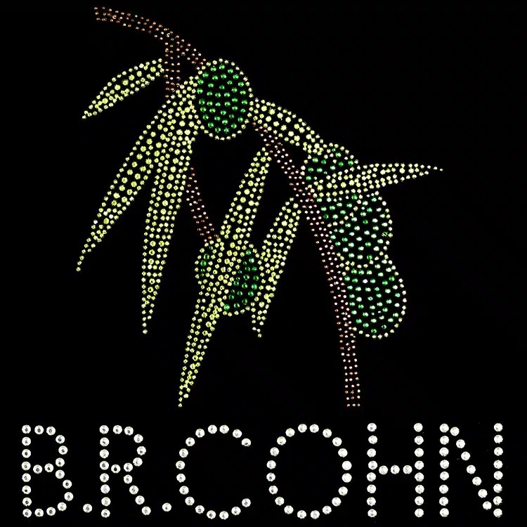 A branch and leaf emblem in green and gold rhinestones, a StudStone heat transfer
