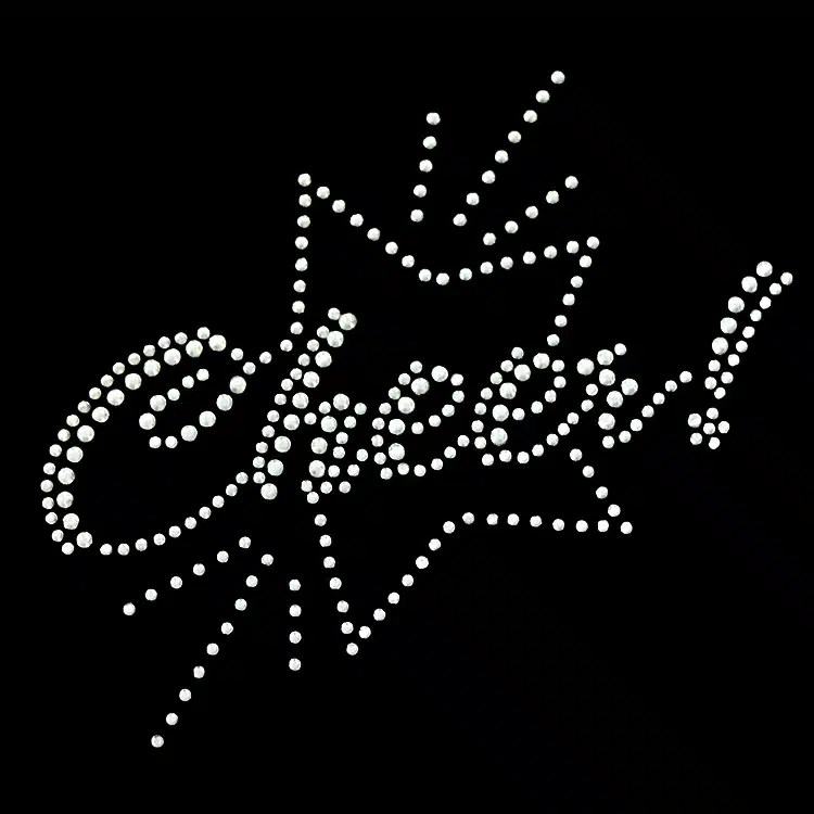 A script wordmark in clear rhinestones with a starburst accent, a StudStone heat transfer