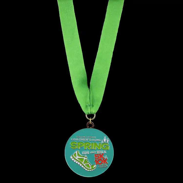 Full colour youth finisher medal on a printed green neck ribbon.
