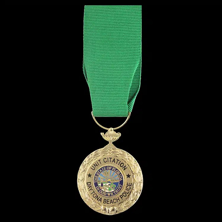 Gold citation medal on a green neck ribbon.