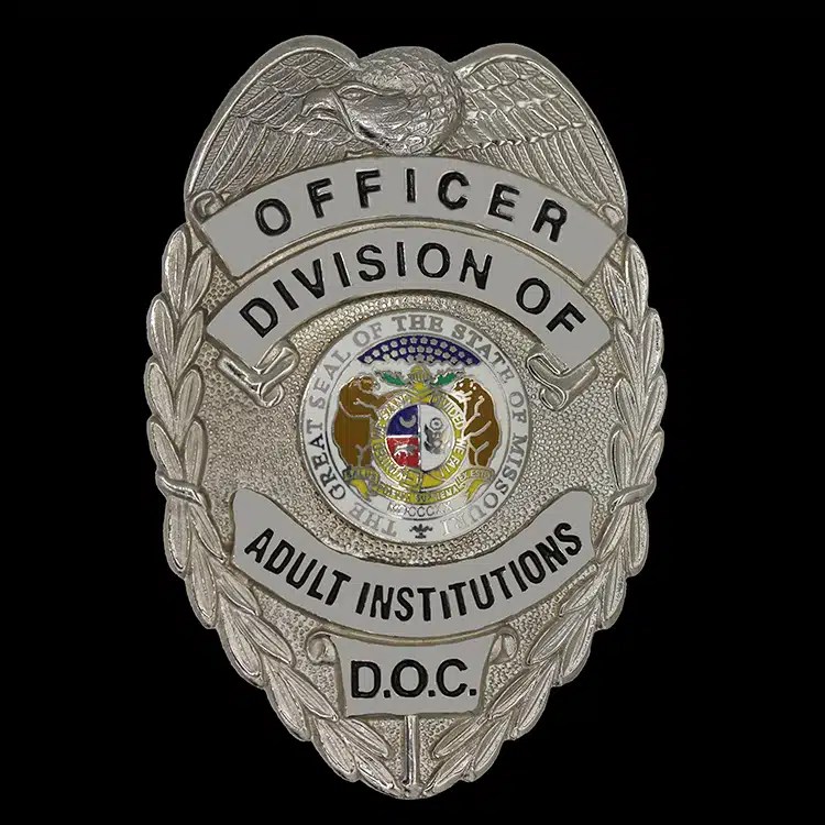Silver shield-shaped officer badge with an eagle at the center.