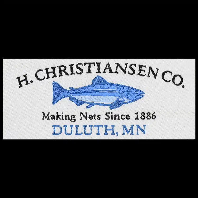 H. Christiansen Co. Making Nets Since 1886 Duluth Minnesota woven label with a blue fish graphic.