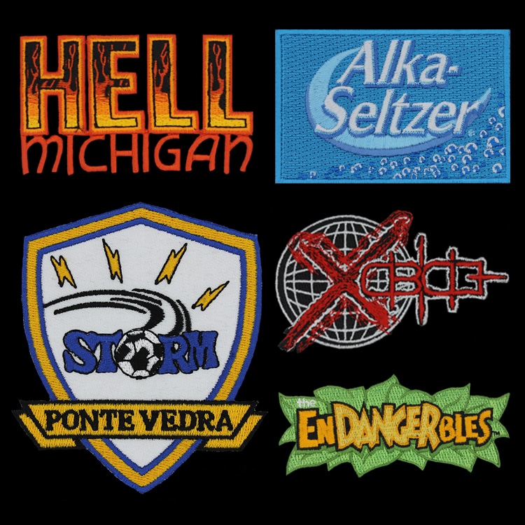A grid of six embroidered patches in different shapes and colourways, showing a range of finished artwork on fabric.